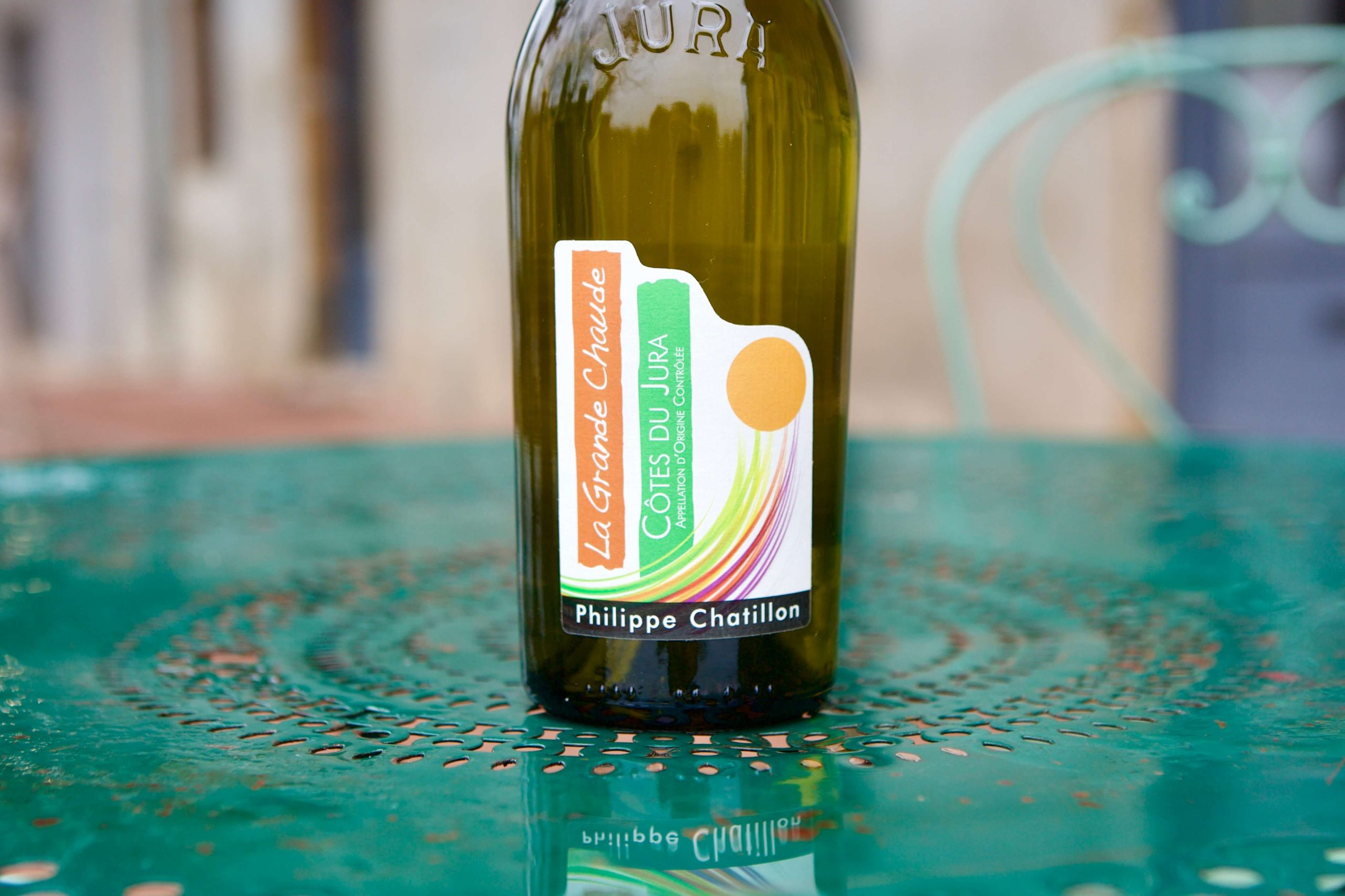 Green bottle of La Grande Chaude on a green table