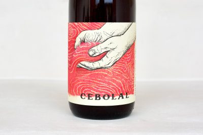 Herdade do Cebolal Portuguese red wine bottle label featuring illustrated hands artwork