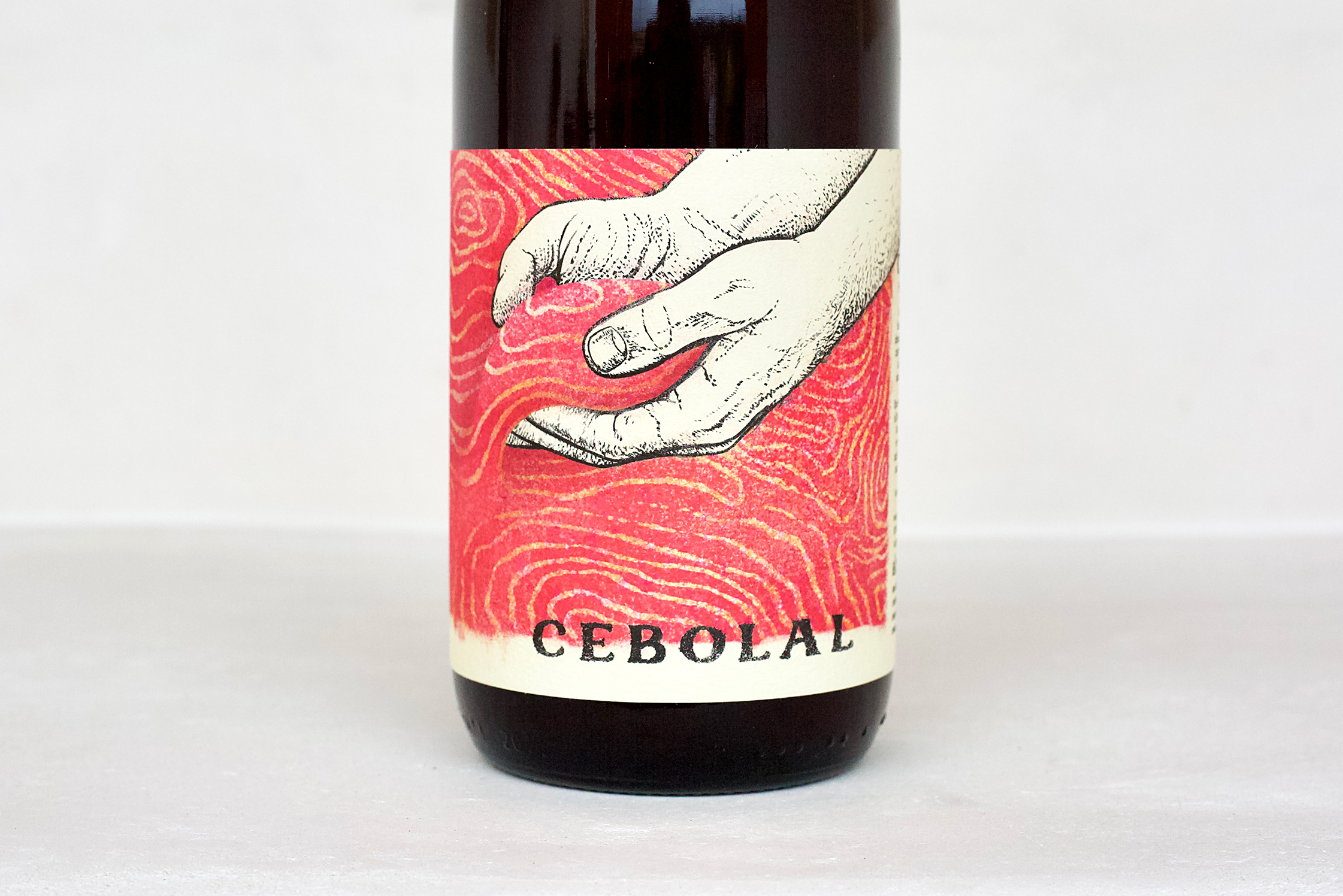 Herdade do Cebolal Portuguese red wine bottle label featuring illustrated hands artwork