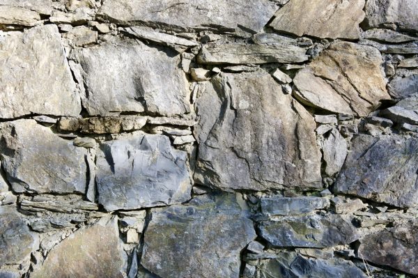 Traditional dry stone wall surrounding Maneterra's vineyards in Liguria, Italy.